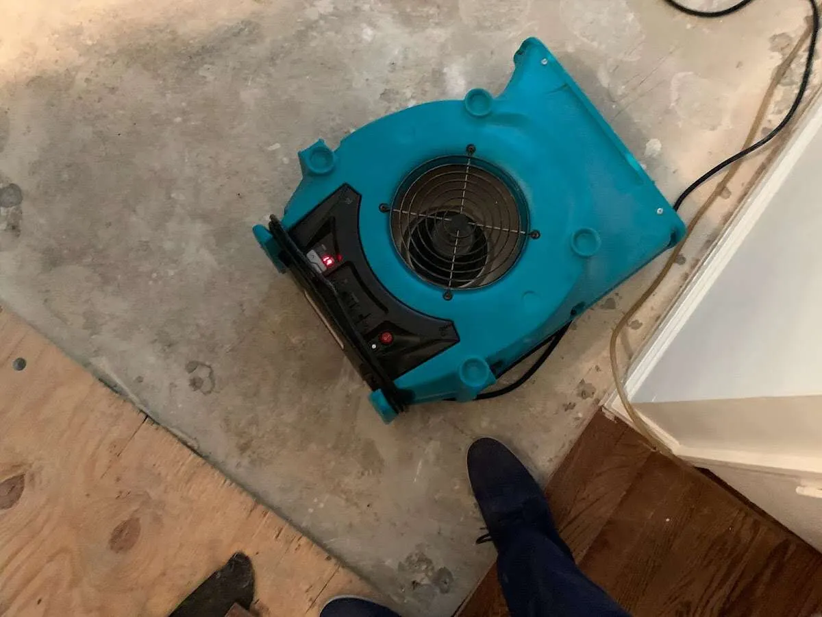 Air mover drying subfloor during Commercial Water Damage Restoration in Steubenville